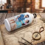 Custom Printed Photo Water Bottle featuring a personalized couple's beach photograph with full-wrap vibrant printing and carabiner clip.