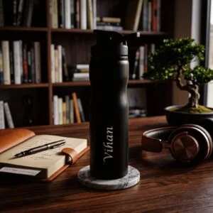 Personalized matte black sports water bottle with a custom name printed on the side