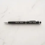 Custom engraved slim metal pen with stylus tip, presented as a premium gift