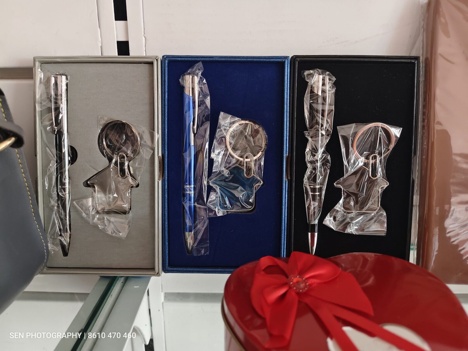 Corporate gift boxes with engraved pens and keychains ready for dispatch