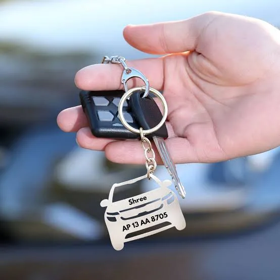 Custom car keychain with name and number plate held with car keys