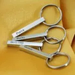 Engraved bar keychains with names and a date