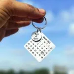 Custom calendar keychain engraved with a wedding date and names