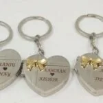 Set of engraved heart keychains with couple names and gold bows