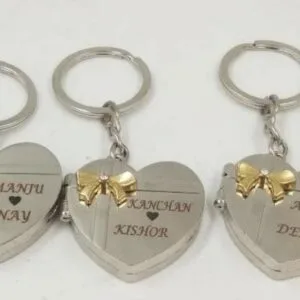 Set of engraved heart keychains with couple names and gold bows