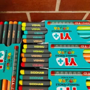 Triangle school pencils printed with childrens names in boxes