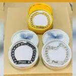 Personalised chain bracelets packed in gift tins with engraved names