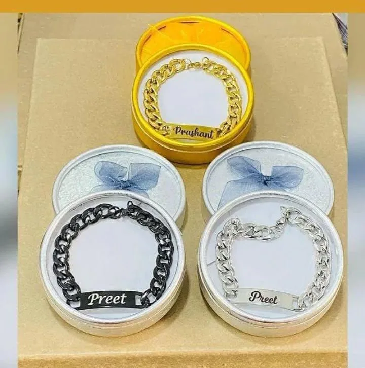 Personalised chain bracelets packed in gift tins with engraved names