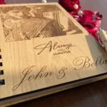Engraved wooden album cover with a couple portrait and their names