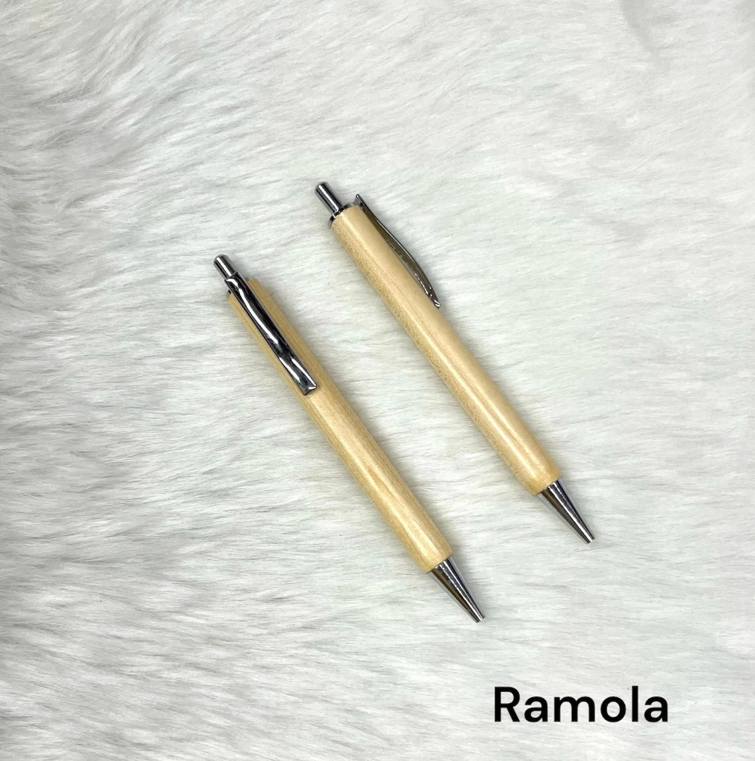 Two light wood pens engraved with a personalised name