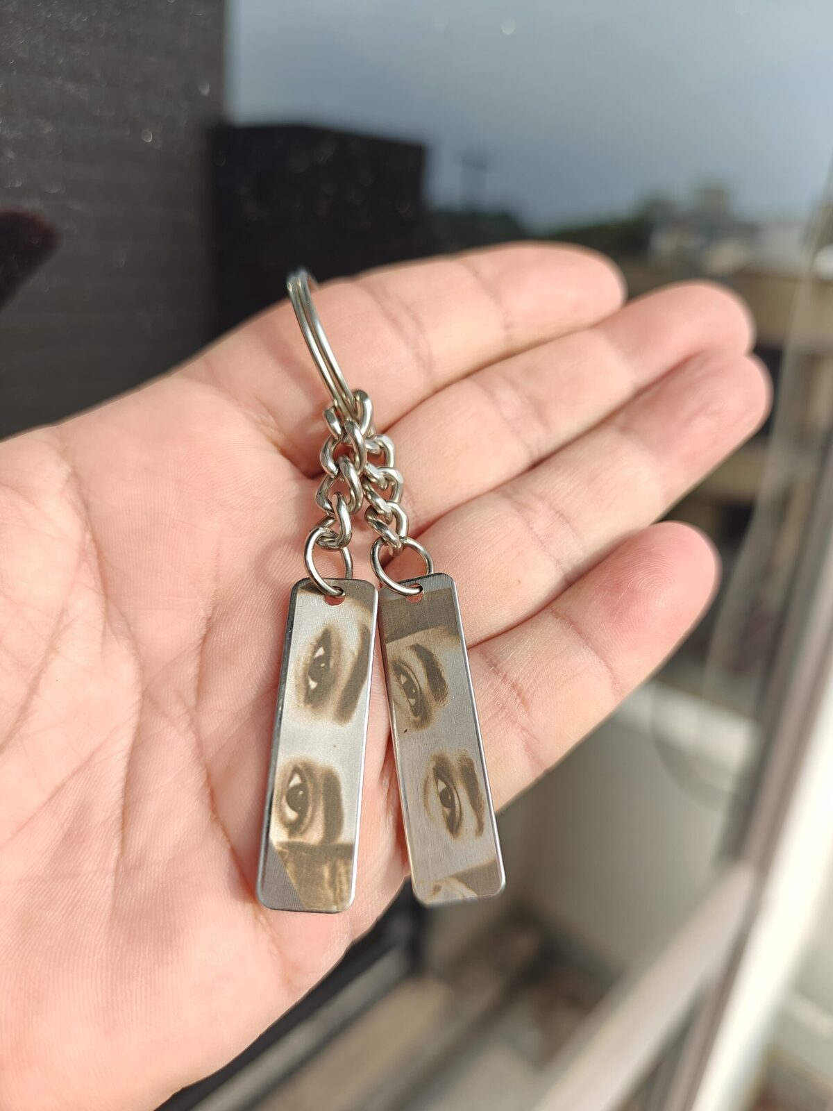 Pair of steel keyrings with photographs laser engraved on them