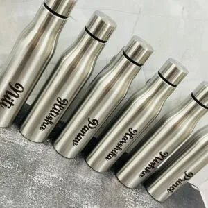Row of classic curved steel water bottles engraved with different names