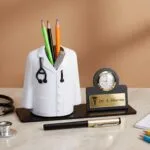 Doctor coat pen stand with a desk clock and engraved name plate