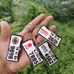 Acrylic number plate keychains printed with vehicle registration numbers and brand logos