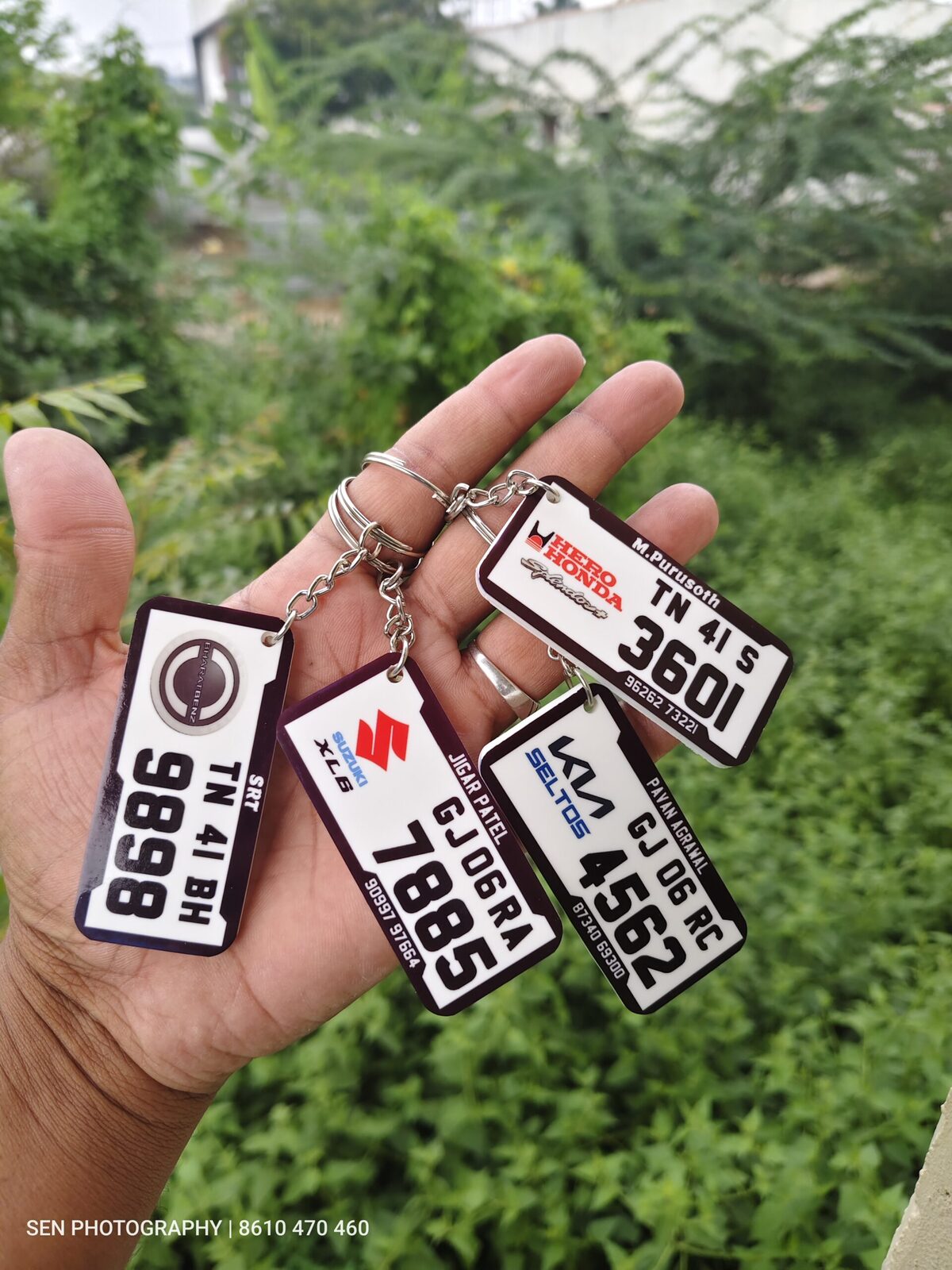 Acrylic number plate keychains printed with vehicle registration numbers and brand logos