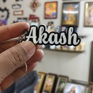 Acrylic name keychain with the name Akash cut in raised 3D white letters