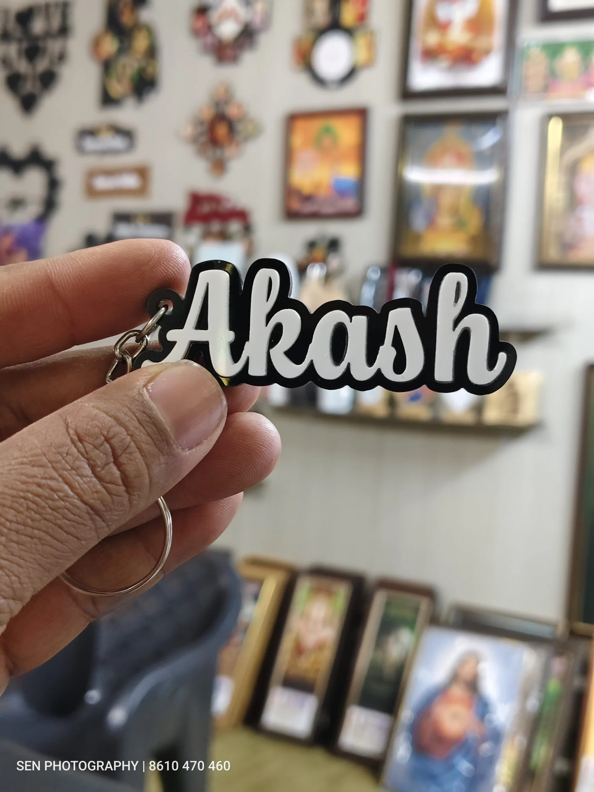 Acrylic name keychain with the name Akash cut in raised 3D white letters