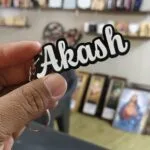 Custom cut acrylic letter keyring with a cursive name