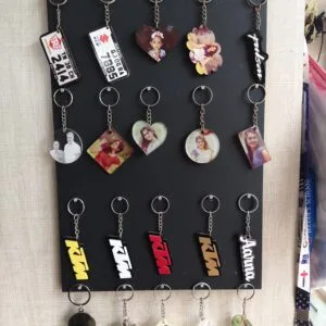 Rack of acrylic photo keychains in heart, round and square shapes