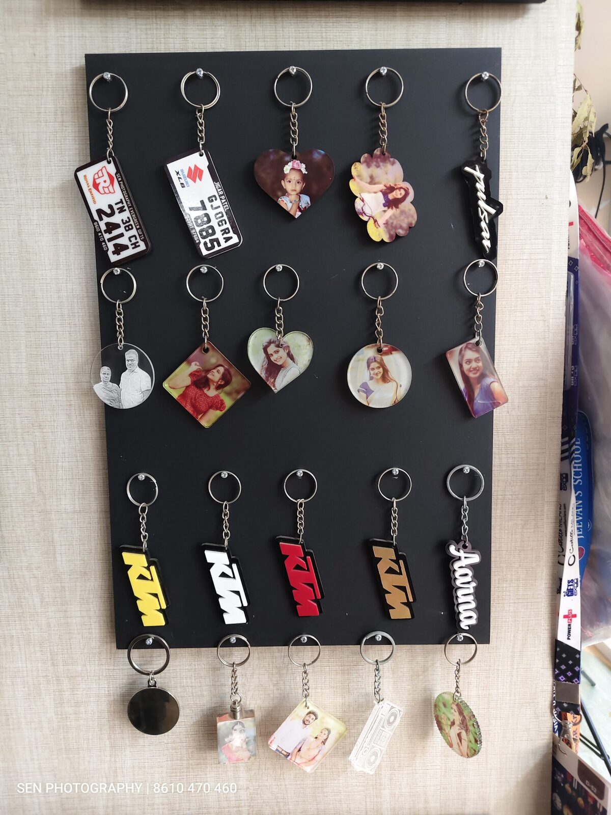 Rack of acrylic photo keychains in heart, round and square shapes
