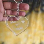 Clear acrylic heart keychain engraved with two names