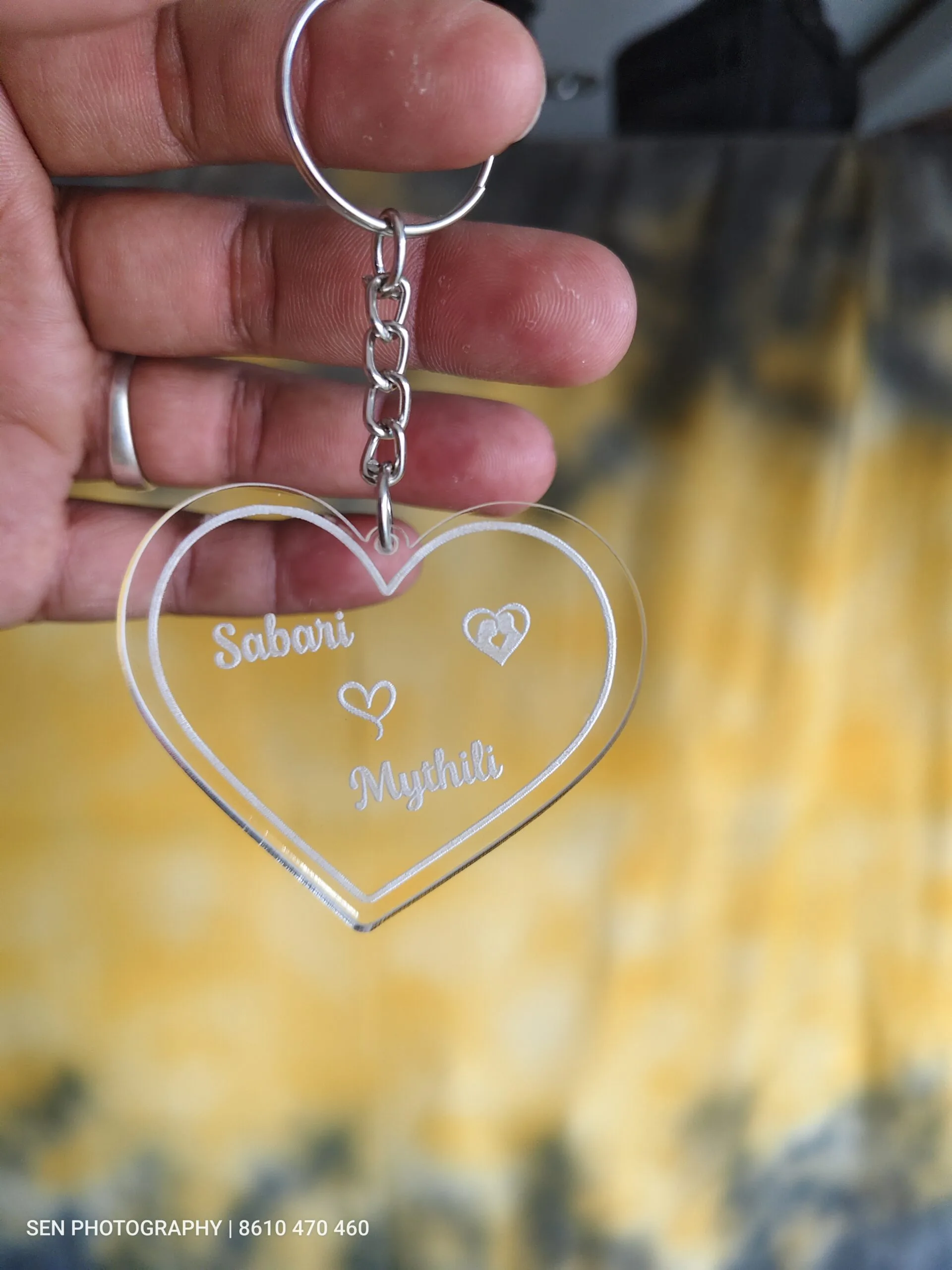 Clear acrylic heart keychain engraved with two names