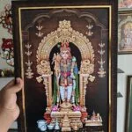 Framed Murugan picture held in hand