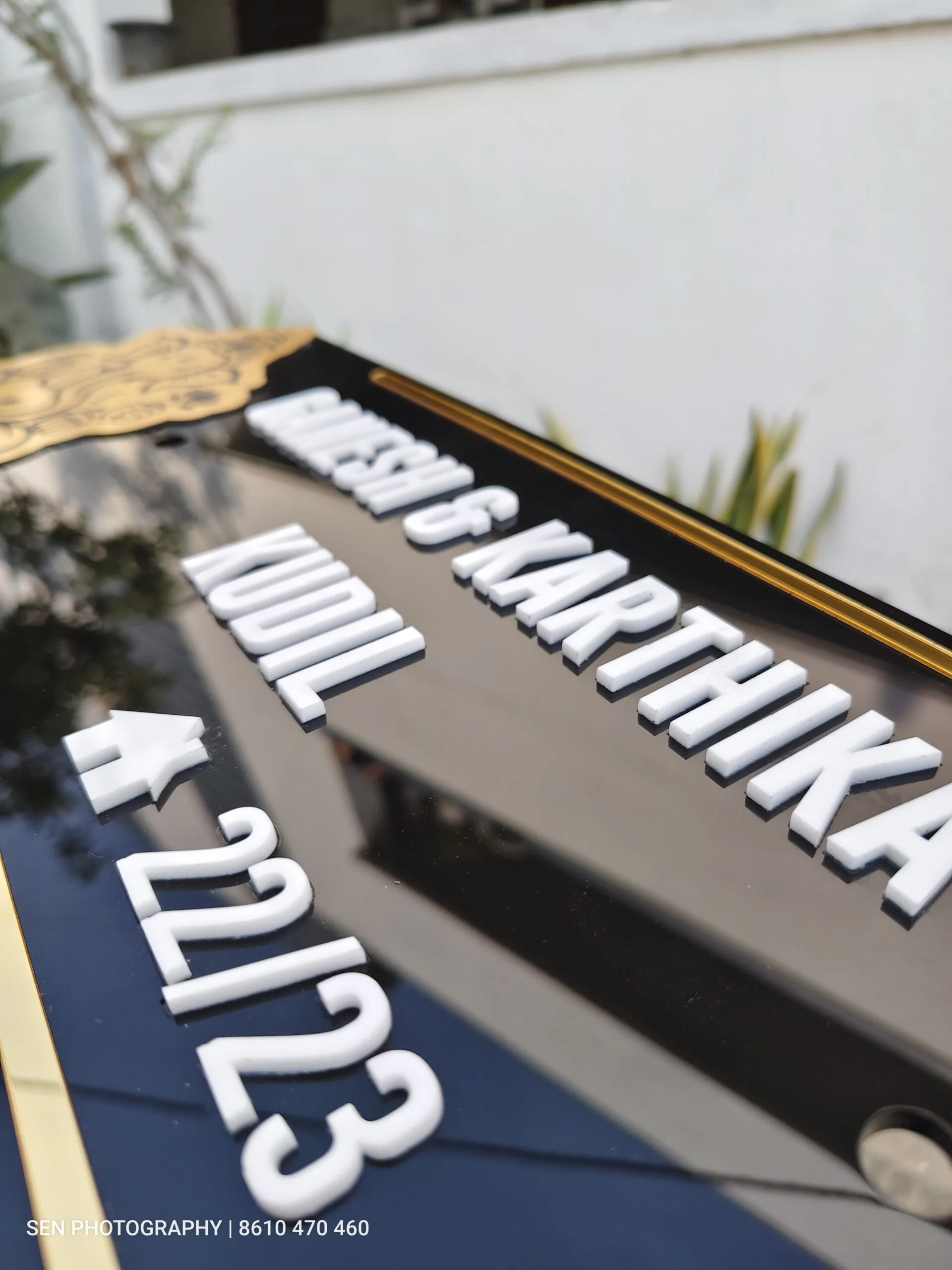 Raised white lettering on a compact acrylic name plate
