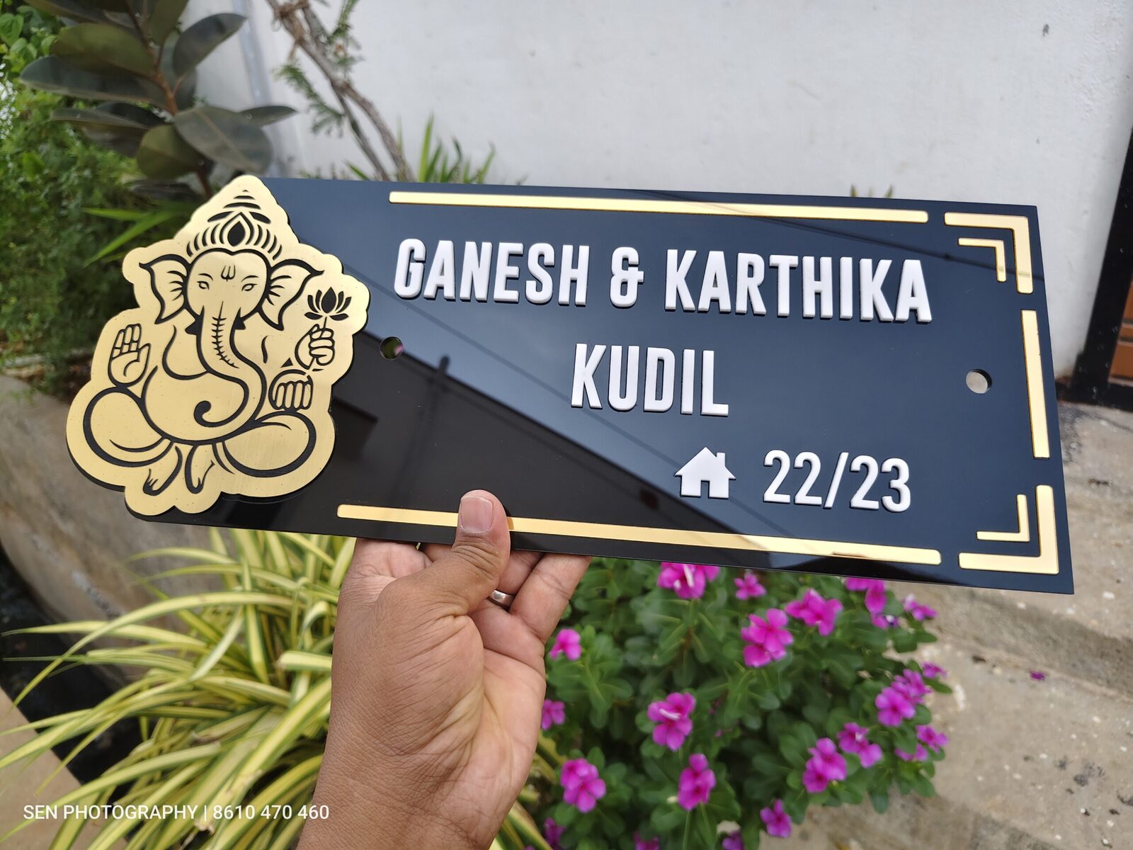 Black acrylic name board with gold Ganesha and Ganesh Karthika Kudil lettering