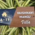 Wood finish house name board with door number A-11 on a black panel