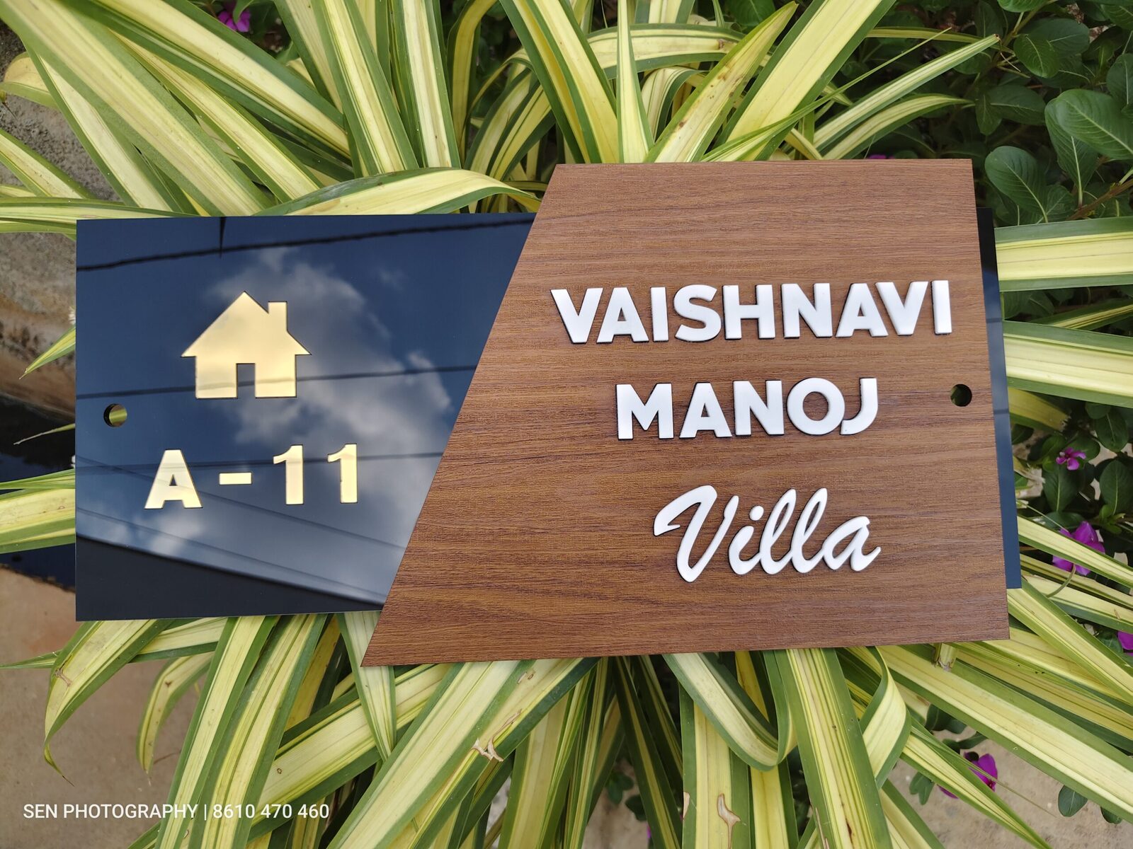 Wood finish house name board with door number A-11 on a black panel