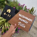 Wooden name board angled to show the depth of the raised letters
