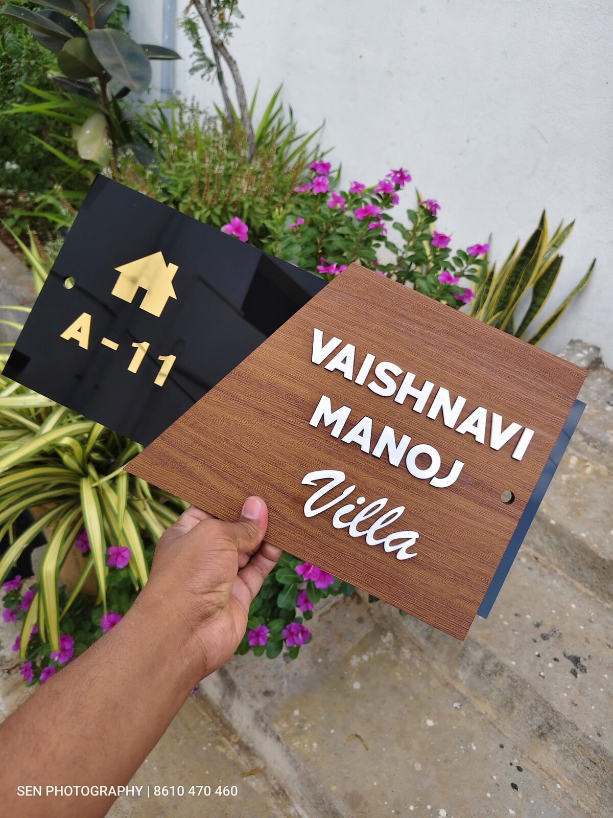 Wooden name board angled to show the depth of the raised letters