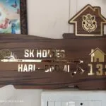 Wood finish name board with arrow and feather design for SK Homes