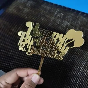 Gold mirror acrylic cake topper reading Happy Birthday with a name