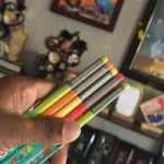 Colourful name printed pencils held in hand