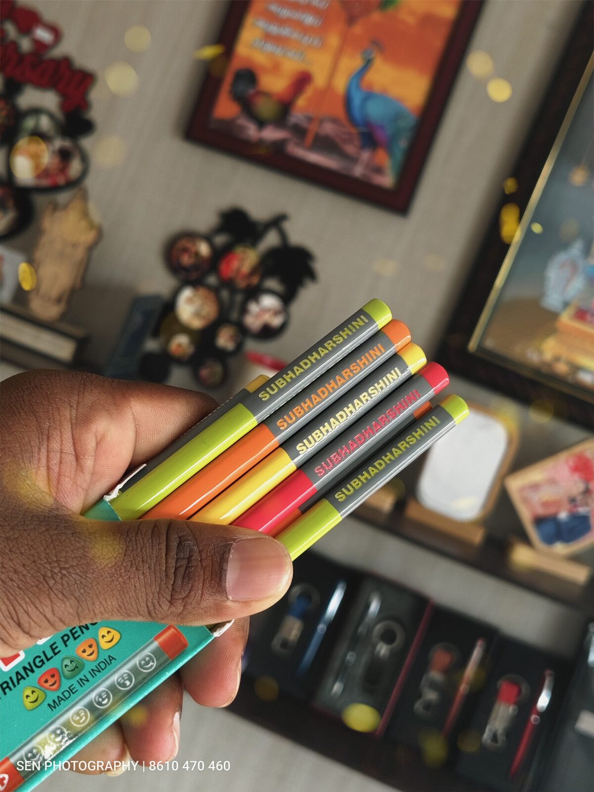 Colourful name printed pencils held in hand
