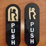 Acrylic letter signage in gold and white on a black board