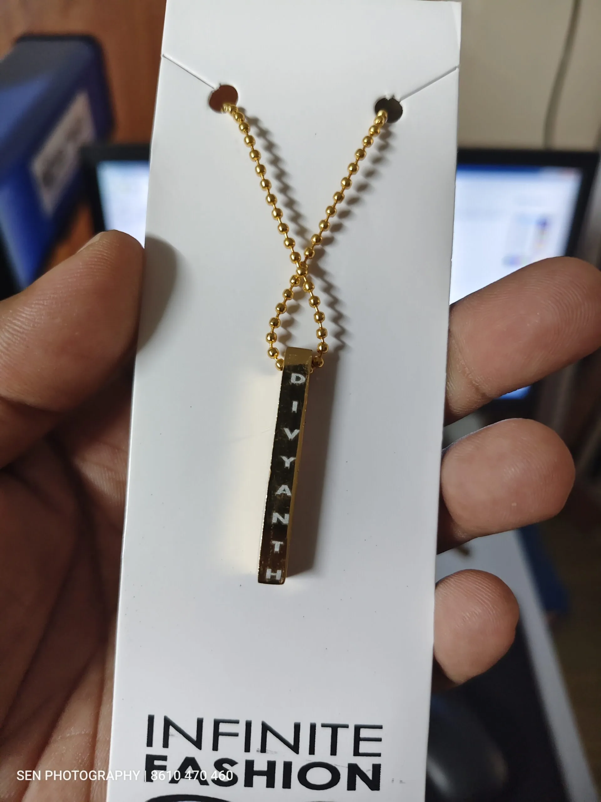 Personalised bar pendant engraved with a name on a ball chain