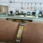 Gold steel name bracelet engraved with a name worn on the wrist