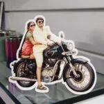 Acrylic photo cutout standee of a couple on a motorcycle