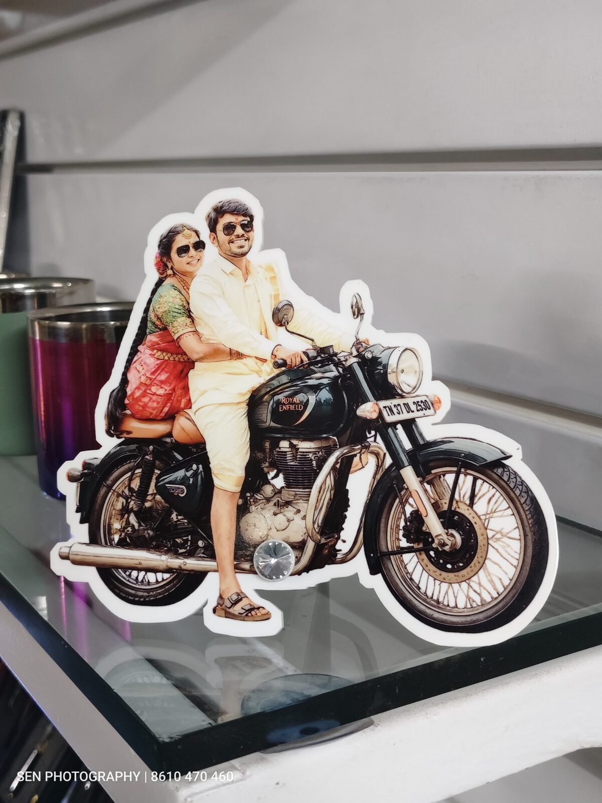 Acrylic photo cutout standee of a couple on a motorcycle