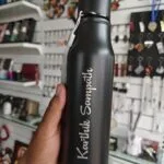 Matte black steel water bottle with a name engraved in script