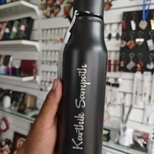 Matte black steel water bottle with a name engraved in script