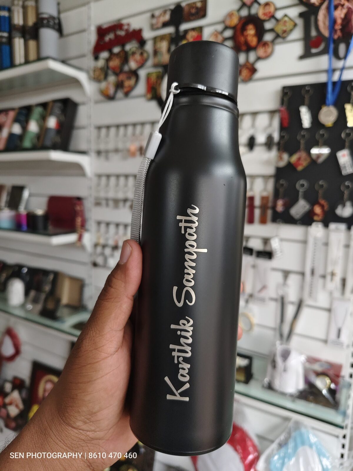 Matte black steel water bottle with a name engraved in script