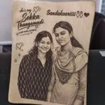 Wooden photo frame engraved with a portrait of two friends and Tamil text