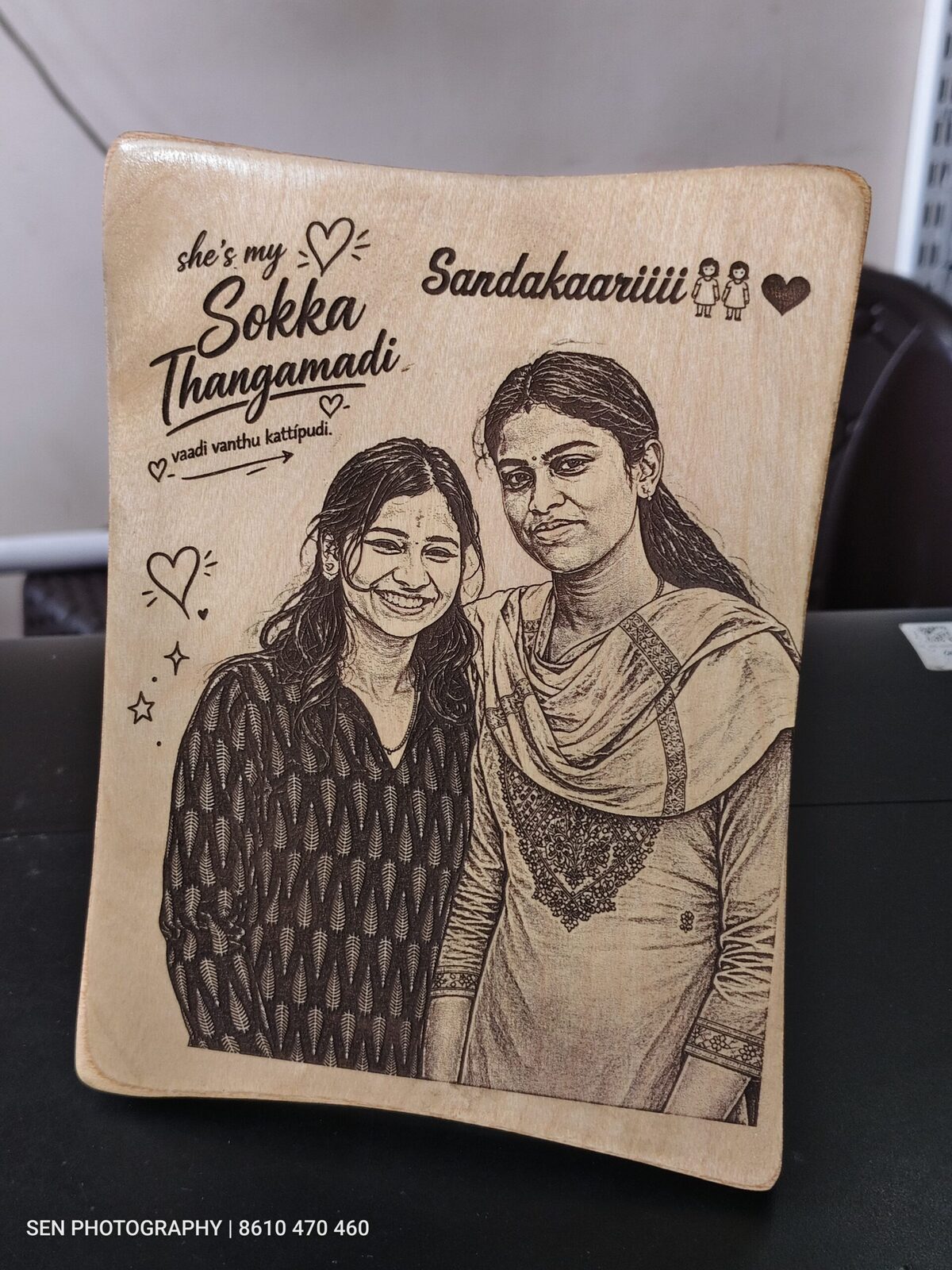 Wooden photo frame engraved with a portrait of two friends and Tamil text