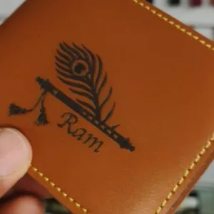 Tan leather wallet laser engraved with a name and peacock feather design